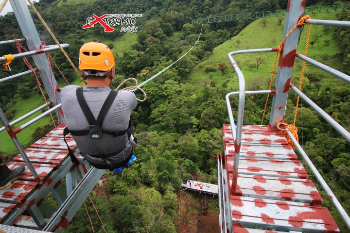 a man jumping off the Monteverde Extremo Mega Swing Platform